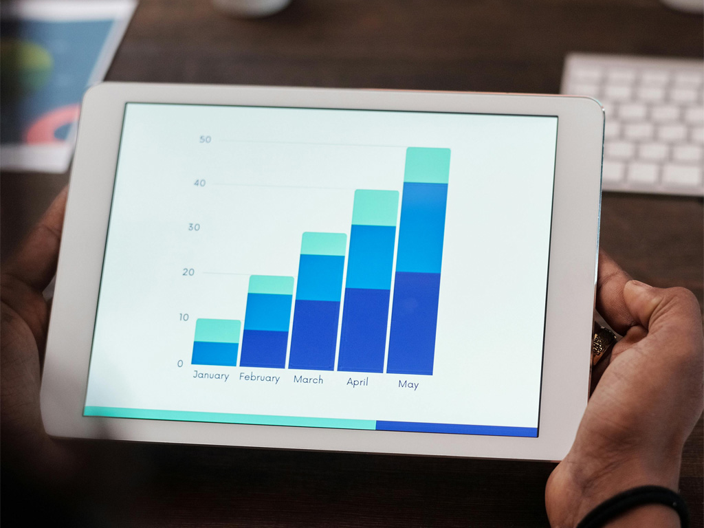 A businessman holding a graph of his lead generation performance statistics.